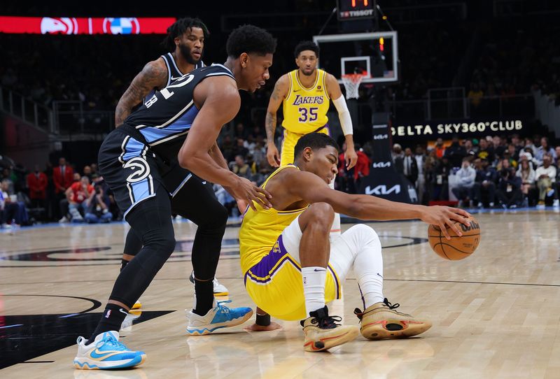 ATLANTA, GEORGIA - JANUARY 30:  Rui Hachimura #28 of the Los Angeles Lakers falls down as he dribbles against De'Andre Hunter #12 of the Atlanta Hawks during the first quarter at State Farm Arena on January 30, 2024 in Atlanta, Georgia.  NOTE TO USER: User expressly acknowledges and agrees that, by downloading and/or using this photograph, user is consenting to the terms and conditions of the Getty Images License Agreement.  (Photo by Kevin C. Cox/Getty Images). (Photo by Kevin C. Cox/Getty Images)