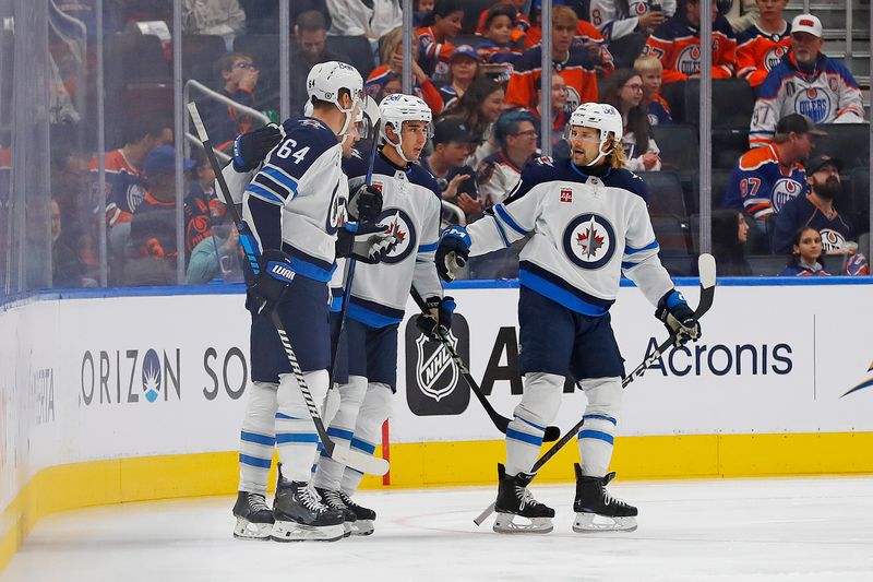 Sep 22, 2024; Edmonton, Alberta, CAN; The Winnipeg Jets celebrate a goal scored by Winnipeg Jets forward David Gustafson (19) during the first period against the Edmonton Oilers at Rogers Place. Mandatory Credit: Perry Nelson-Imagn Images