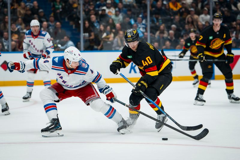 Oct 28, 2025; Vancouver, British Columbia, CAN; New York Rangers defenseman Braden Schneider (4) stick checks Vancouver Canucks forward Elias Pettersson (40) in the second period at Rogers Arena. Mandatory Credit: Bob Frid-Imagn Images