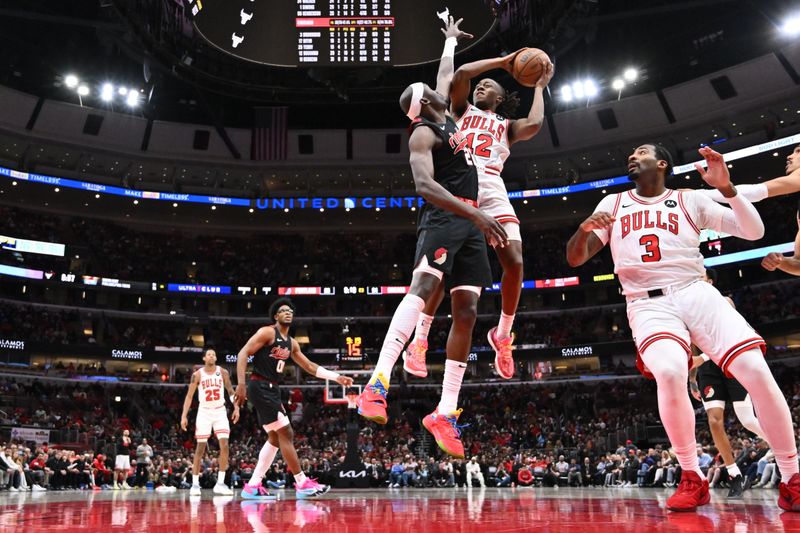 CHICAGO, ILLINOIS - MARCH 18:  Ayo Dosunmu #12 of the Chicago Bulls goes up for a shot against Duop Reath #26 of the Portland Trail Blazers in the second half on March 18, 2024 at United Center in Chicago, Illinois. Chicago defeated Portland 110-107.   NOTE TO USER: User expressly acknowledges and agrees that, by downloading and or using this photograph, User is consenting to the terms and conditions of the Getty Images License Agreement.  (Photo by Jamie Sabau/Getty Images)