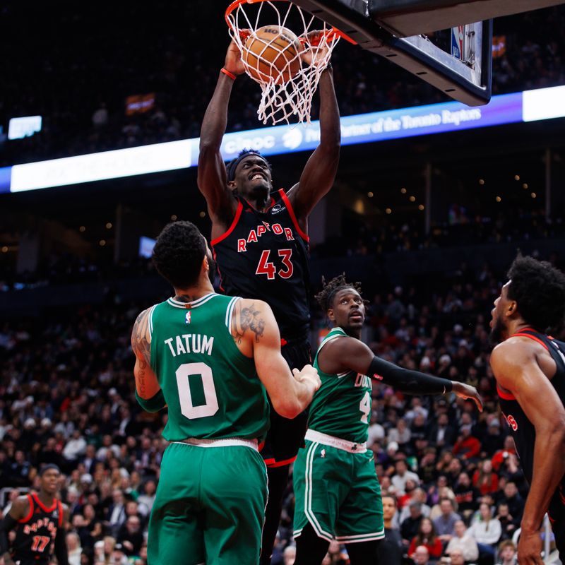 TORONTO, CANADA - JANUARY 15: Pascal Siakam #43 of the Toronto Raptors dunks against Jayson Tatum #0 of the Boston Celtics during the second half of their NBA game at Scotiabank Arena on January 15, 2024 in Toronto, Canada. NOTE TO USER: User expressly acknowledges and agrees that, by downloading and or using this photograph, User is consenting to the terms and conditions of the Getty Images License Agreement. (Photo by Cole Burston/Getty Images)