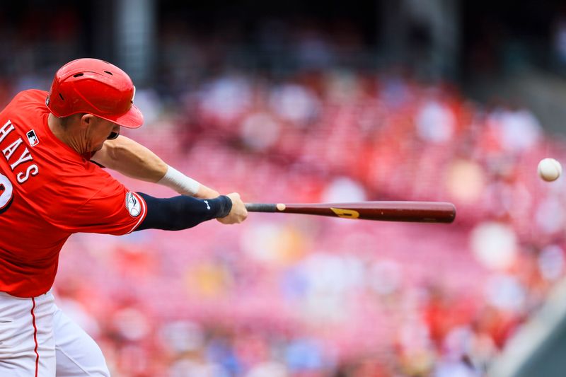 Aug 17, 2025; Cincinnati, Ohio, USA; Cincinnati Reds designated hitter Austin Hays (12) hits a double in the seventh inning against the Milwaukee Brewers at Great American Ball Park. Mandatory Credit: Katie Stratman-Imagn Images