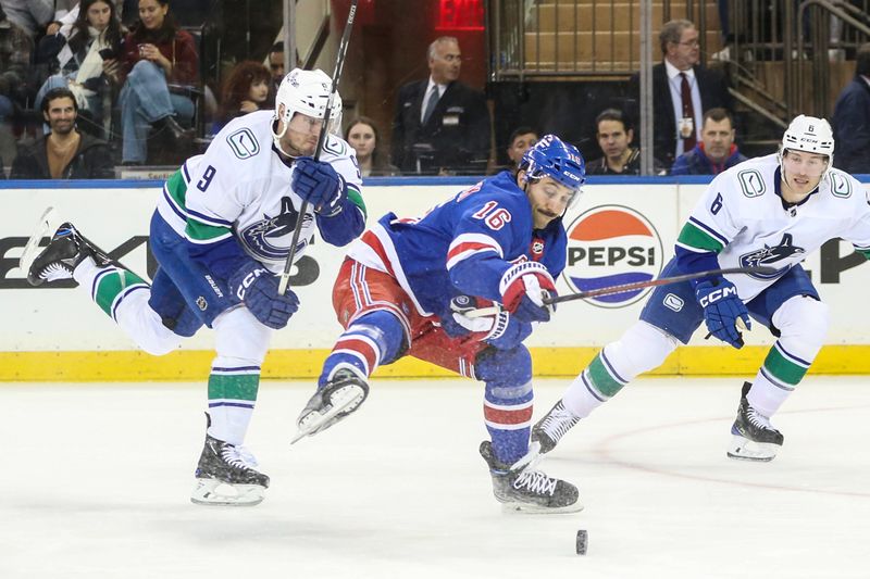 Jan 8, 2024; New York, New York, USA;  Vancouver Canucks center J.T. Miller (9) and New York Rangers center Vincent Trocheck (16) chases the puck in the first period at Madison Square Garden. Mandatory Credit: Wendell Cruz-USA TODAY Sports