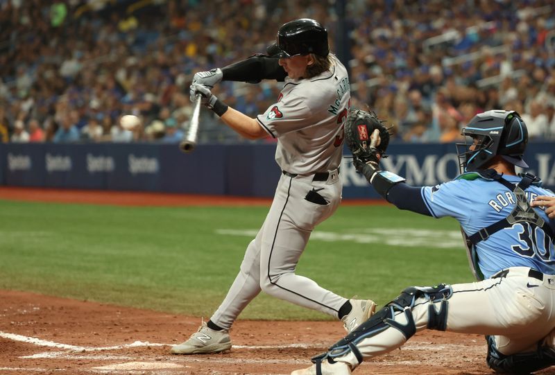 Aug 18, 2024; St. Petersburg, Florida, USA;  Arizona Diamondbacks outfielder Jake McCarthy (31) hits a sacrifice RBI against the Tampa Bay Rays during the seventh inning at Tropicana Field. Mandatory Credit: Kim Klement Neitzel-USA TODAY Sports