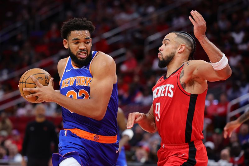 HOUSTON, TEXAS - NOVEMBER 04: Karl-Anthony Towns #32 of the New York Knicks drives against Dillon Brooks #9 of the Houston Rockets during the first half at Toyota Center on November 04, 2024 in Houston, Texas. NOTE TO USER: User expressly acknowledges and agrees that, by downloading and or using this photograph, User is consenting to the terms and conditions of the Getty Images License Agreement.  (Photo by Alex Slitz/Getty Images)