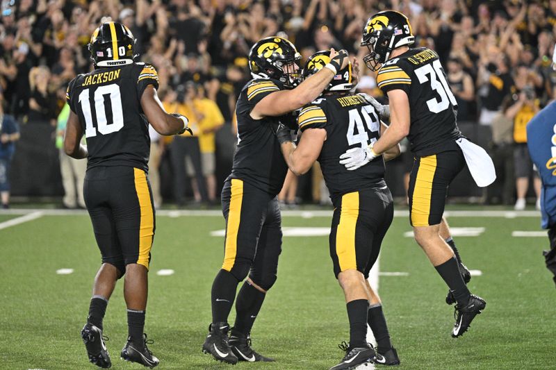 Sep 30, 2023; Iowa City, Iowa, USA; Iowa Hawkeyes defensive lineman Ethan Hurkett (49) and defensive back Quinn Schulte (30) and linebacker Nick Jackson (10) react during the fourth quarter against the Michigan State Spartans at Kinnick Stadium. Mandatory Credit: Jeffrey Becker-USA TODAY Sports