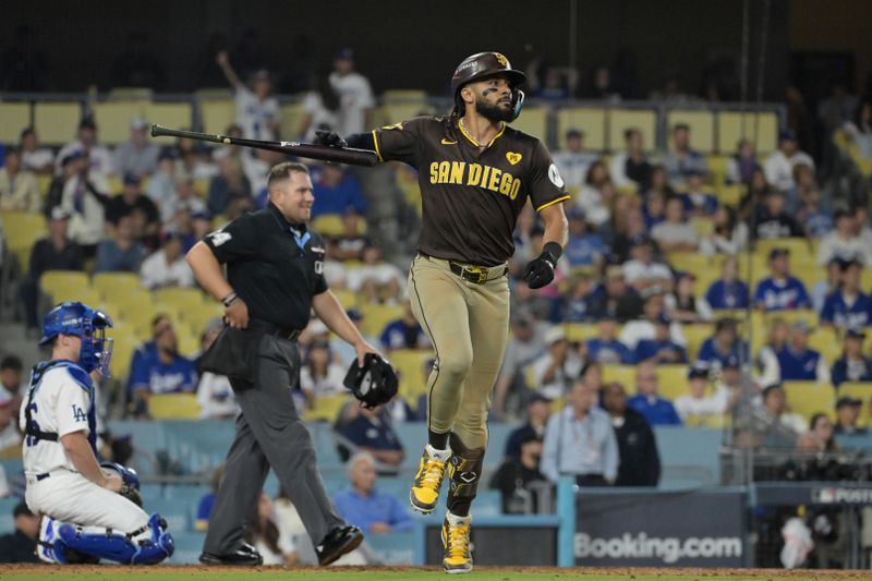 Oct 6, 2024; Los Angeles, California, USA; San Diego Padres outfielder Fernando Tatis Jr. (23) hits a two run home run in the ninth inning against the Los Angeles Dodgers during game two of the NLDS for the 2024 MLB Playoffs at Dodger Stadium. Mandatory Credit: Jayne Kamin-Oncea-Imagn Images