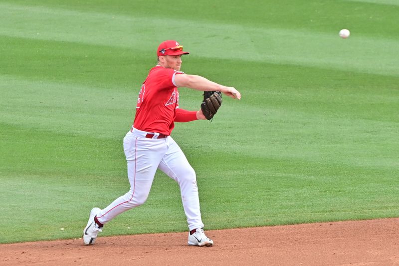 Mar 6, 2024; Tempe, Arizona, USA;  Los Angeles Angels second baseman Brandon Drury (23) throws to first base inn the third inning against the Oakland Athletics during a spring training game at Tempe Diablo Stadium. Mandatory Credit: Matt Kartozian-USA TODAY Sports