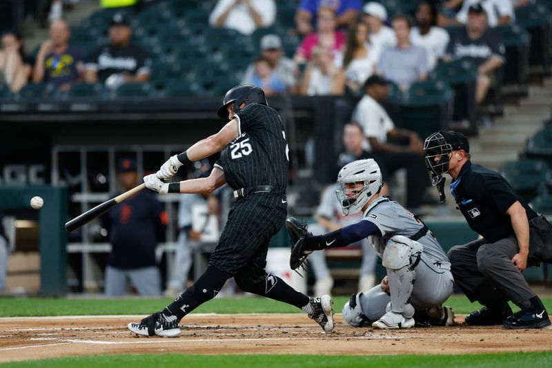 Aug 26, 2024; Chicago, Illinois, USA; Chicago White Sox first baseman Andrew Vaughn (25) hits an RBI-sacrifice fly against the Detroit Tigers during the first inning at Guaranteed Rate Field. Mandatory Credit: Kamil Krzaczynski-USA TODAY Sports