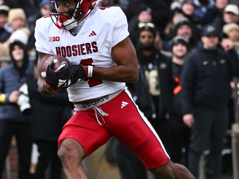 Nov 25, 2023; West Lafayette, Indiana, USA; Indiana Hoosiers wide receiver DeQuece Carter (4) runs a catch in for a touchdown during the first half at Ross-Ade Stadium. Mandatory Credit: Robert Goddin-USA TODAY Sports