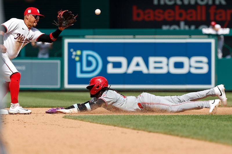 Jul 21, 2024; Washington, District of Columbia, USA; Cincinnati Reds shortstop Elly De La Cruz (44) steals second base ahead of a throw to Washington Nationals second base Ildemaro Vargas (14) during the eighth inning at Nationals Park. Mandatory Credit: Geoff Burke-USA TODAY Sports