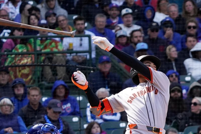 May 7, 2025; Chicago, Illinois, USA; San Francisco Giants outfielder Jung Hoo Lee (51) loses his bat against the Chicago Cubs during the seventh inning at Wrigley Field. Mandatory Credit: David Banks-Imagn Images