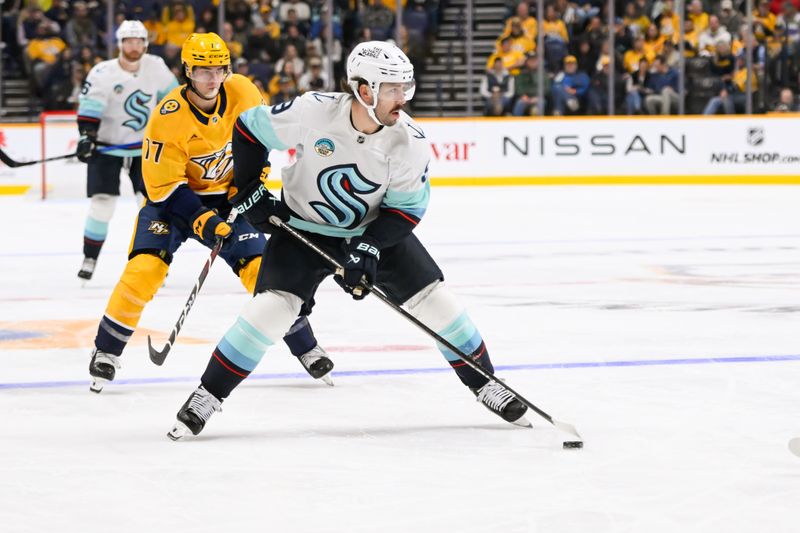 Oct 15, 2024; Nashville, Tennessee, USA;  Seattle Kraken center Chandler Stephenson (9) skates with the puck against the Nashville Predators during the second period at Bridgestone Arena. Mandatory Credit: Steve Roberts-Imagn Images