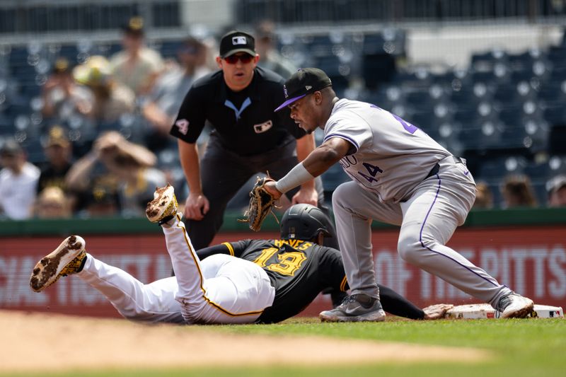 May 5, 2024; Pittsburgh, Pennsylvania, USA; Pittsburgh Pirates third baseman Ke'Bryan Hayes (13) dives back to first base beating a tag by Colorado Rockies first baseman Elehuris Montero (44) from an attempted pickoff during the fourth inning at PNC Park. Mandatory Credit: Scott Galvin-USA TODAY Sports