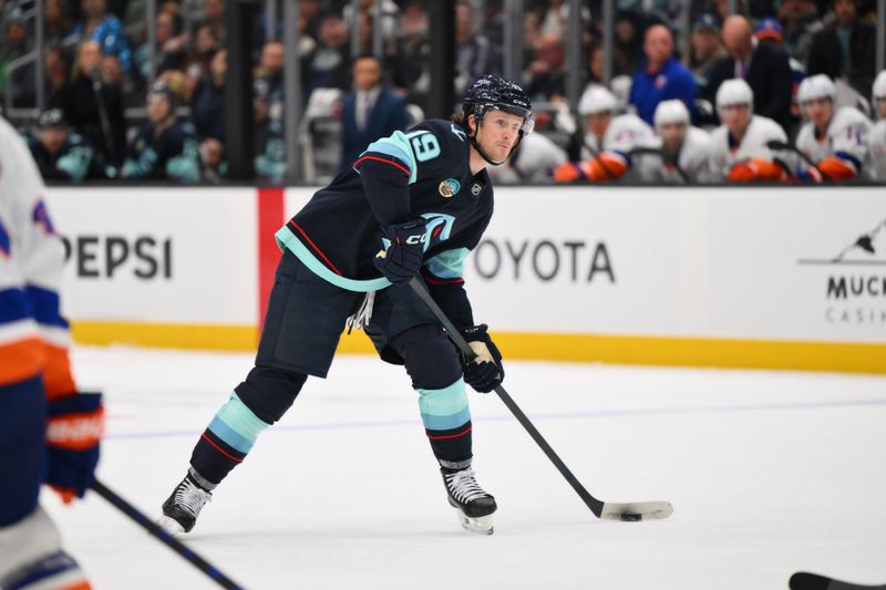 Nov 16, 2024; Seattle, Washington, USA; Seattle Kraken left wing Jared McCann (19) plays the puck during the third period against the New York Islanders at Climate Pledge Arena. Mandatory Credit: Steven Bisig-Imagn Images