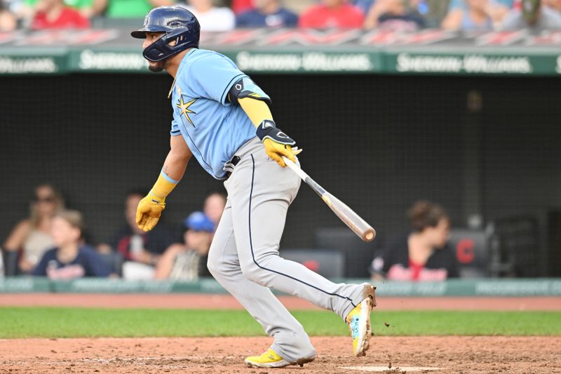 Sep 3, 2023; Cleveland, Ohio, USA; Tampa Bay Rays third baseman Isaac Paredes (17) hits an RBI single during the ninth inning against the Cleveland Guardians at Progressive Field. Mandatory Credit: Ken Blaze-USA TODAY Sports
