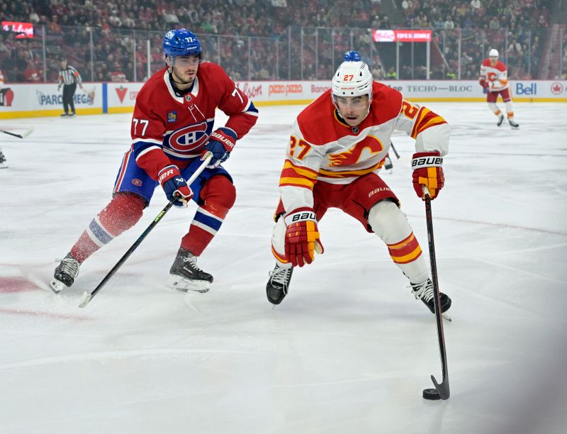 Nov 5, 2024; Montreal, Quebec, CAN; Calgary Flames forward Matt Coronato (27) plays the puck and Montreal Canadiens forward Kirby Dach (77) defends during the first period at the Bell Centre. Mandatory Credit: Eric Bolte-Imagn Images