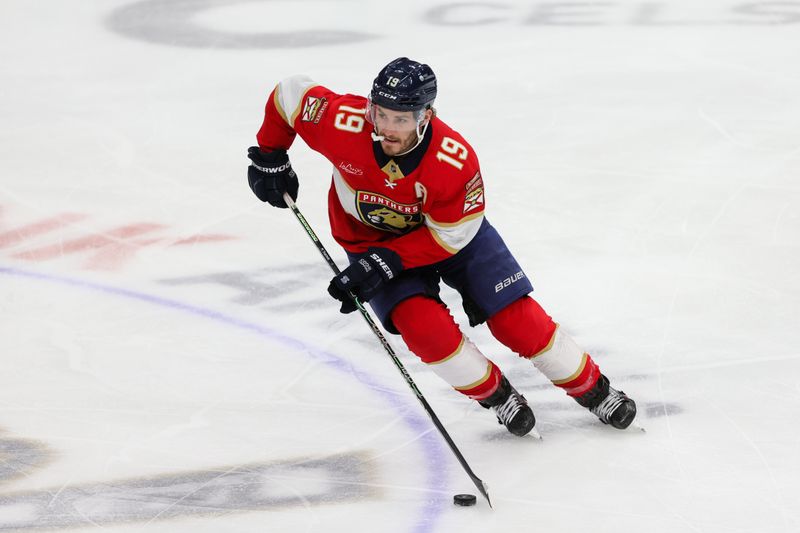 Feb 27, 2024; Sunrise, Florida, USA; Florida Panthers left wing Matthew Tkachuk (19) moves the puck against the Buffalo Sabres during the first period at Amerant Bank Arena. Mandatory Credit: Sam Navarro-USA TODAY Sports