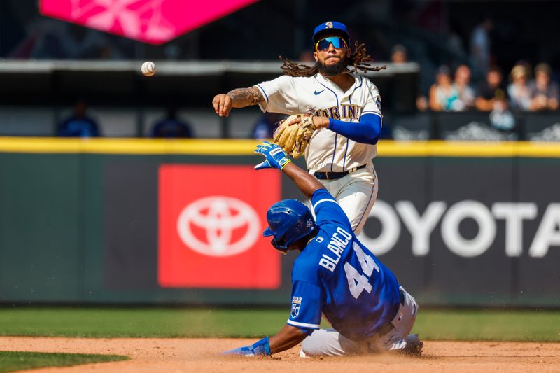 Aug 27, 2023; Seattle, Washington, USA; Seattle Mariners shortstop J.P. Crawford (3) attempts to turn a double play against Kansas City Royals pinch runner Dairon Blanco (44) during the eighth inning at T-Mobile Park. Mandatory Credit: Joe Nicholson-USA TODAY Sports