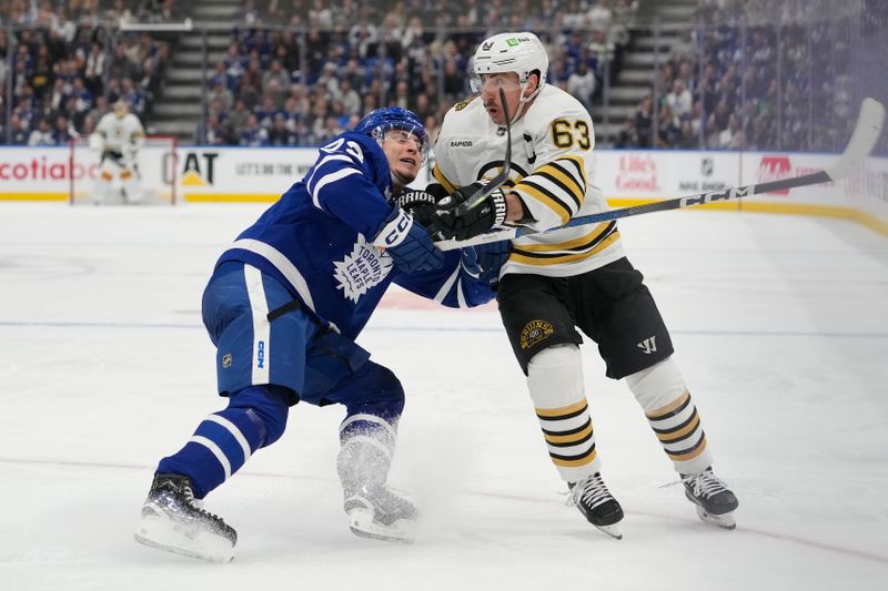 Apr 24, 2024; Toronto, Ontario, CAN; Toronto Maple Leafs forward Matthew Knies (23) battles with Boston Bruins forward Brad Marchand (63) during the second period of game three of the first round of the 2024 Stanley Cup Playoffs at Scotiabank Arena. Mandatory Credit: John E. Sokolowski-USA TODAY Sports