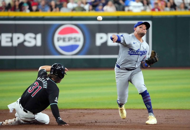 Sep 2, 2024; Phoenix, Arizona, USA; Arizona Diamondbacks catcher Jose Herrera (11) throws to first to double up Arizona Diamondbacks designated hitter Joc Pederson (not pictured) after forcing out Arizona Diamondbacks outfielder Jake McCarthy (31) at second during the first inning at Chase Field. Mandatory Credit: Joe Camporeale-USA TODAY Sports