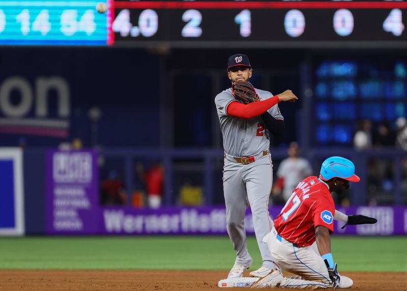 Apr 27, 2024; Miami, Florida, USA; Washington Nationals second baseman Luis Garcia Jr. (2) turns a double play against the Miami Marlins during the fourth inning at loanDepot Park. Mandatory Credit: Sam Navarro-USA TODAY Sports