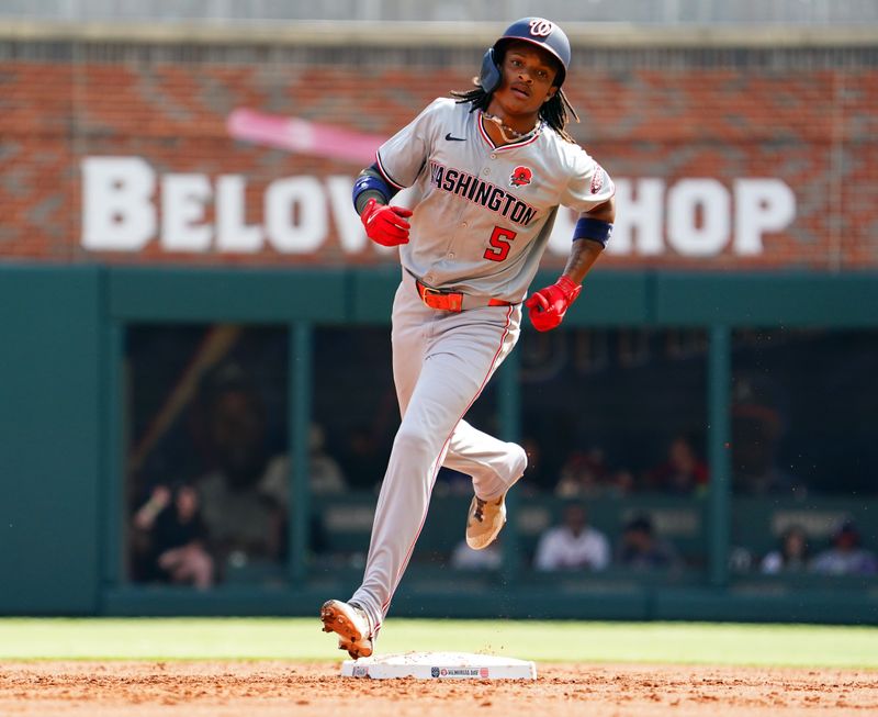 May 27, 2024; Cumberland, Georgia, USA; Washington Nationals shortstop CJ Abrams (5) rounds second base after his solo home against the Atlanta Braves during the second inning at Truist Park. Mandatory Credit: John David Mercer-USA TODAY Sports