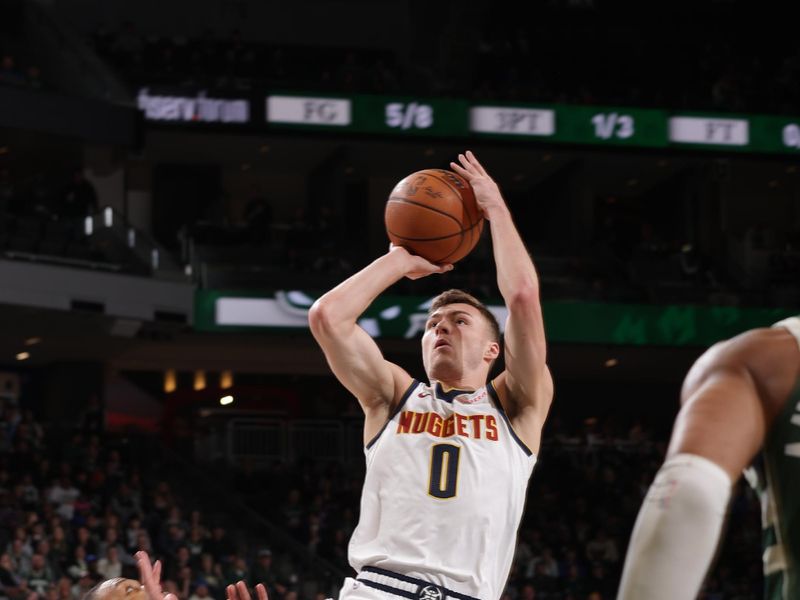 MILWAUKEE, WI - FEBRUARY 27: Christian Braun #0 of the Denver Nuggets shoots the ball during the game against the Milwaukee Bucks on February 27, 2025 at Fiserv Forum Center in Milwaukee, Wisconsin. NOTE TO USER: User expressly acknowledges and agrees that, by downloading and or using this Photograph, user is consenting to the terms and conditions of the Getty Images License Agreement. Mandatory Copyright Notice: Copyright 2025 NBAE (Photo by Gary Dineen/NBAE via Getty Images).