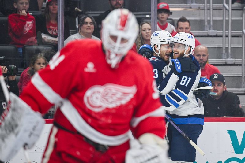 Oct 30, 2024; Detroit, Michigan, USA; Winnipeg Jets center Gabriel Vilardi (13) celebrates his goal with left wing Kyle Connor (81) as Detroit Red Wings goaltender Alex Lyon (34) reacts during the first period at Little Caesars Arena. Mandatory Credit: Tim Fuller-Imagn Images