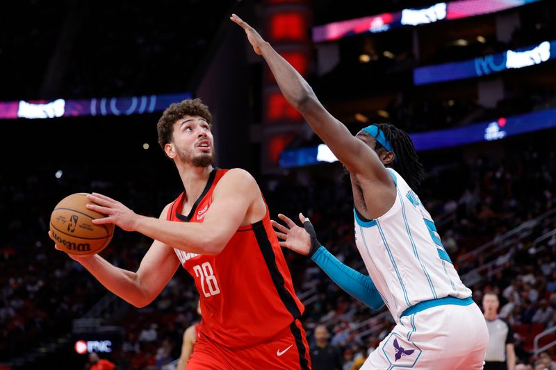 HOUSTON, TEXAS - NOVEMBER 01: Alperen Sengun #28 of the Houston Rockets controls the ball ahead of Mark Williams #5 of the Charlotte Hornets during the first half at Toyota Center on November 01, 2023 in Houston, Texas. (Photo by Carmen Mandato/Getty Images)