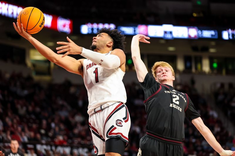 Jan 14, 2023; Columbia, South Carolina, USA; South Carolina Gamecocks guard Jacobi Wright (1) drives past Texas A&M Aggies guard Khalen Robinson (1) in the first half at Colonial Life Arena. Mandatory Credit: Jeff Blake-USA TODAY Sports