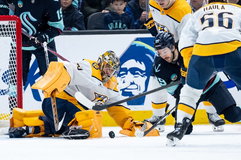 Mar 10, 2026; Seattle, Washington, USA; Nashville Predators goalie Juuse Saros (74) and Seattle Kraken forward Frederick Gaudreau (89) track down a loose puck during the third period at Climate Pledge Arena. Mandatory Credit: Stephen Brashear-Imagn Images