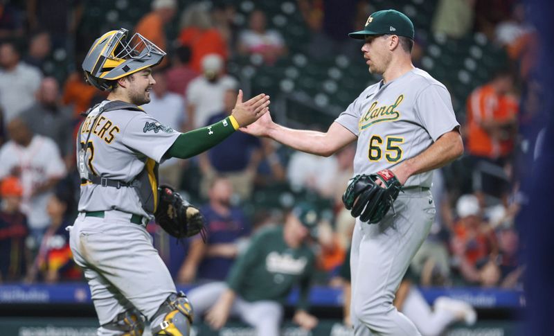 Sep 11, 2023; Houston, Texas, USA; Oakland Athletics catcher Shea Langeliers (23) celebrates with relief pitcher Trevor May (65) after the game against the Houston Astros at Minute Maid Park. Mandatory Credit: Troy Taormina-USA TODAY Sports