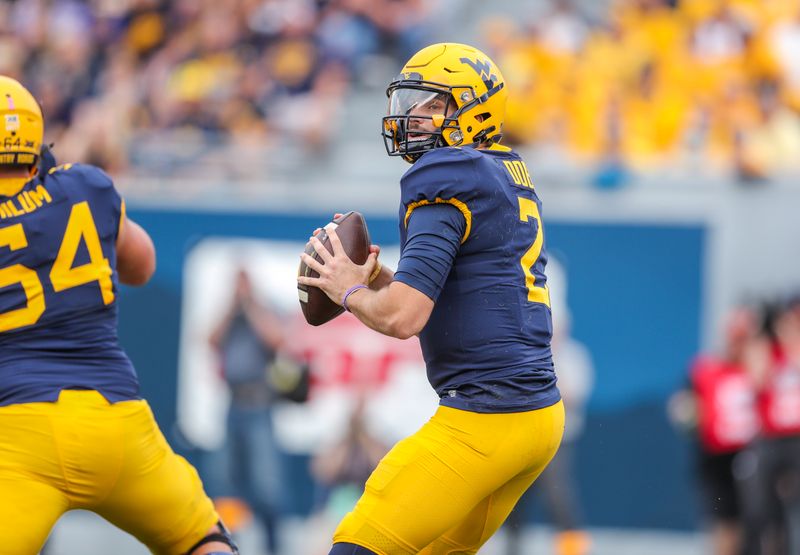 Oct 2, 2021; Morgantown, West Virginia, USA; West Virginia Mountaineers quarterback Jarret Doege (2) drops back for a pass during the first quarter against the Texas Tech Red Raiders at Mountaineer Field at Milan Puskar Stadium. Mandatory Credit: Ben Queen-USA TODAY Sports