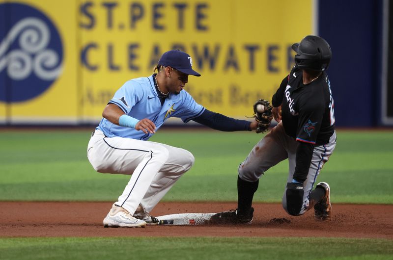 Jul 30, 2024; St. Petersburg, Florida, USA; Miami Marlins shortstop Xavier Edwards (63) steals second base as Tampa Bay Rays infielder Christopher Morel (24) attempts to tag him out at Tropicana Field. Mandatory Credit: Kim Klement Neitzel-USA TODAY Sports