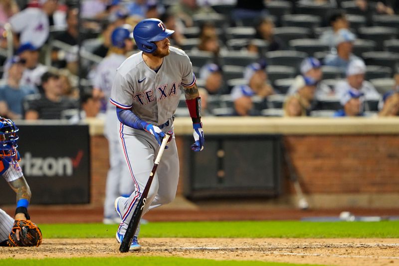 Aug 30, 2023; New York City, New York, USA;  Texas Rangers catcher Jonah Heim (28) hits an RBI single against the New York Mets during the eighth inning at Citi Field. Mandatory Credit: Gregory Fisher-USA TODAY Sports