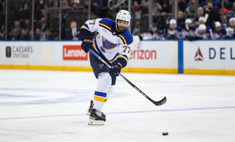 Nov 25, 2024; New York, New York, USA; St. Louis Blues defenseman Pierre-Olivier Joseph (77) passes the puck against the New York Rangers during the third period at Madison Square Garden. Mandatory Credit: Danny Wild-Imagn Images