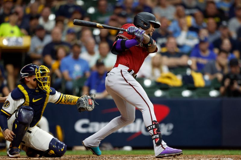 Oct 4, 2023; Milwaukee, Wisconsin, USA; Arizona Diamondbacks second baseman Ketel Marte (4) hits a two RBI single in the sixth inning against the Milwaukee Brewers during game two of the Wildcard series for the 2023 MLB playoffs at American Family Field. Mandatory Credit: Kamil Krzaczynski-USA TODAY Sports