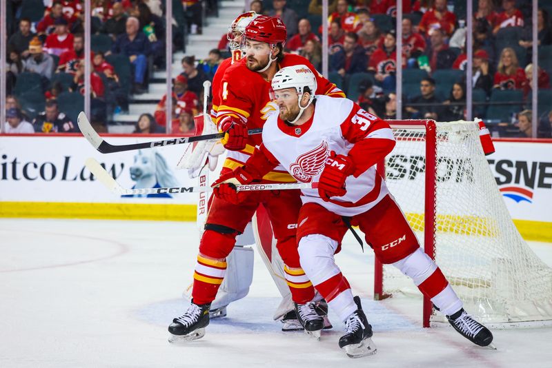 Feb 17, 2024; Calgary, Alberta, CAN; Detroit Red Wings right wing Christian Fischer (36) and Calgary Flames defenseman Rasmussen Andersson (4) fights for position in front of Calgary Flames goaltender Dan Vladar (80) during the second period at Scotiabank Saddledome. Mandatory Credit: Sergei Belski-USA TODAY Sports