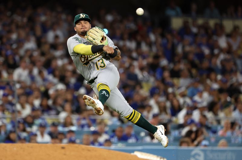 Aug 3, 2023; Los Angeles, California, USA;  Oakland Athletics third baseman Jordan Diaz (13) throws to first during the sixth inning against the Los Angeles Dodgers at Dodger Stadium. Mandatory Credit: Kiyoshi Mio-USA TODAY Sports