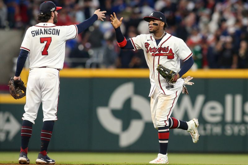Oct 12, 2022; Atlanta, Georgia, USA; Atlanta Braves shortstop Dansby Swanson (left) high-fives right fielder Ronald Acuna Jr. (13) after the final out against the Philadelphia Phillies in the ninth inning in game two of the NLDS for the 2022 MLB Playoffs at Truist Park. Mandatory Credit: Brett Davis-USA TODAY Sports