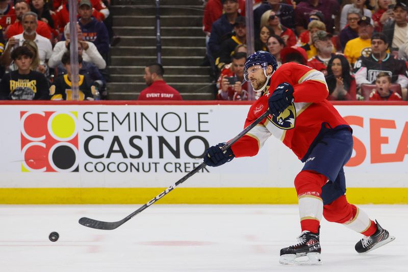 May 14, 2024; Sunrise, Florida, USA; Florida Panthers center Sam Reinhart (13) shoots the puck against the Boston Bruins during the second period in game five of the second round of the 2024 Stanley Cup Playoffs at Amerant Bank Arena. Mandatory Credit: Sam Navarro-USA TODAY Sports