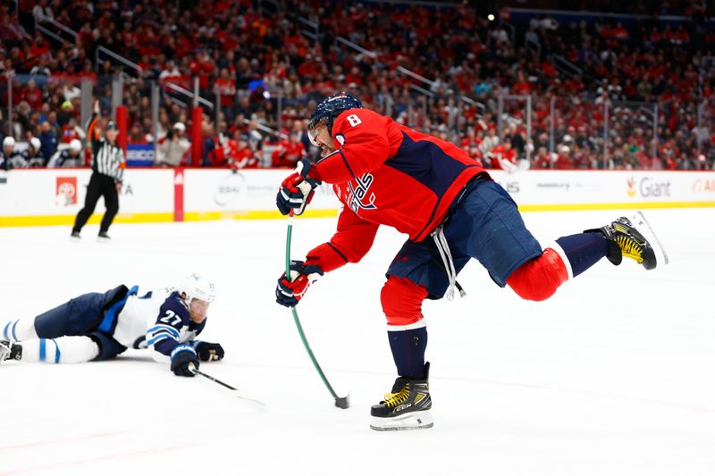 Mar 24, 2024; Washington, District of Columbia, USA; Washington Capitals left wing Alex Ovechkin (8) shoots the puck past Winnipeg Jets left wing Nikolaj Ehlers (27) during the third period at Capital One Arena. Mandatory Credit: Amber Searls-USA TODAY Sports