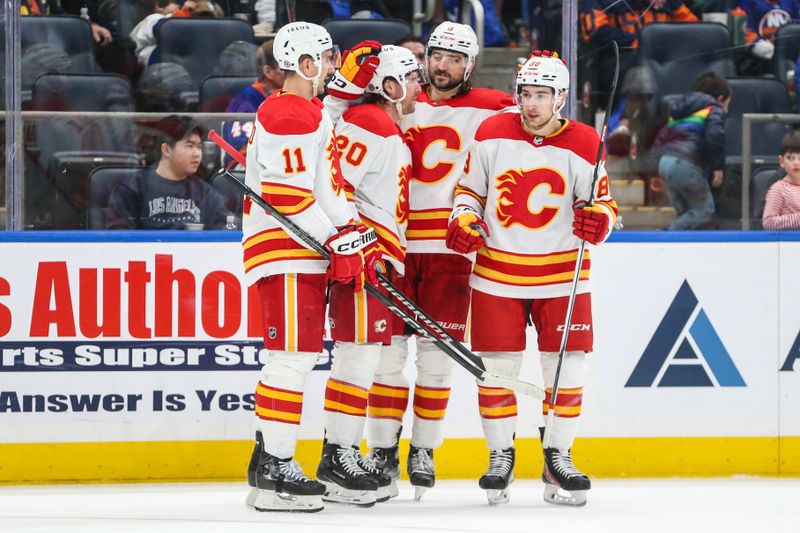 Feb 10, 2024; Elmont, New York, USA;  Calgary Flames center Blake Coleman (20) celebrates with his teammates after scoring a goal in the third period New York Islanders at UBS Arena. Mandatory Credit: Wendell Cruz-USA TODAY Sports