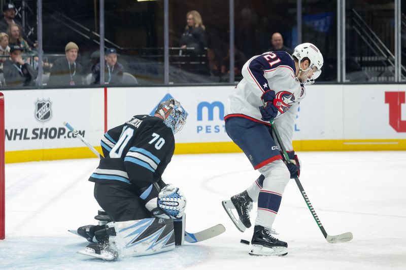 Jan 31, 2025; Salt Lake City, Utah, USA;  Columbus Blue Jackets left wing James van Riemsdyk (21) tries to deflect the puck past Utah Hockey Club goaltender Karel Vejmelka (70) and into the net with his skate during the third period at Delta Center. Mandatory Credit: Chris Nicoll-Imagn Images