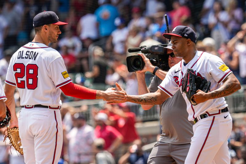 Jun 28, 2023; Cumberland, Georgia, USA; Atlanta Braves relief pitcher Raisel Iglesias (26) reacts with first baseman Matt Olson (28) after the Braves defeated the Minnesota Twins at Truist Park. Mandatory Credit: Dale Zanine-USA TODAY Sports