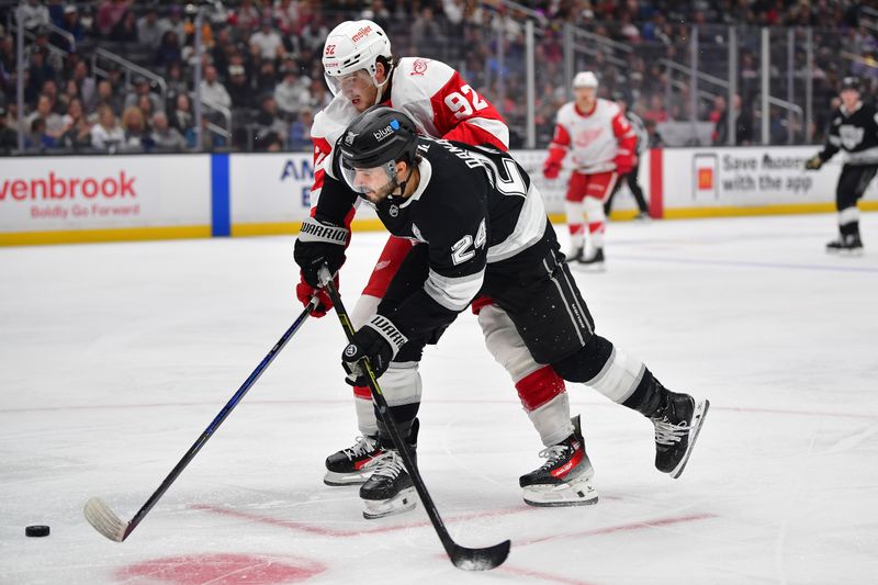 Oct 30, 2025; Los Angeles, California, USA; Los Angeles Kings center Phillip Danault (24) moves the puck against Detroit Red Wings center Marco Kasper (92) during the second period at Crypto.com Arena. Mandatory Credit: Gary A. Vasquez-Imagn Images
