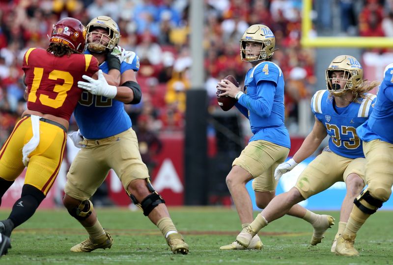 Nov 18, 2023; Los Angeles, California, USA; UCLA Bruins quarterback Ethan Garbers (4) drops to throw during the first quarter against the USC Trojans at United Airlines Field at Los Angeles Memorial Coliseum. Mandatory Credit: Jason Parkhurst-USA TODAY Sports