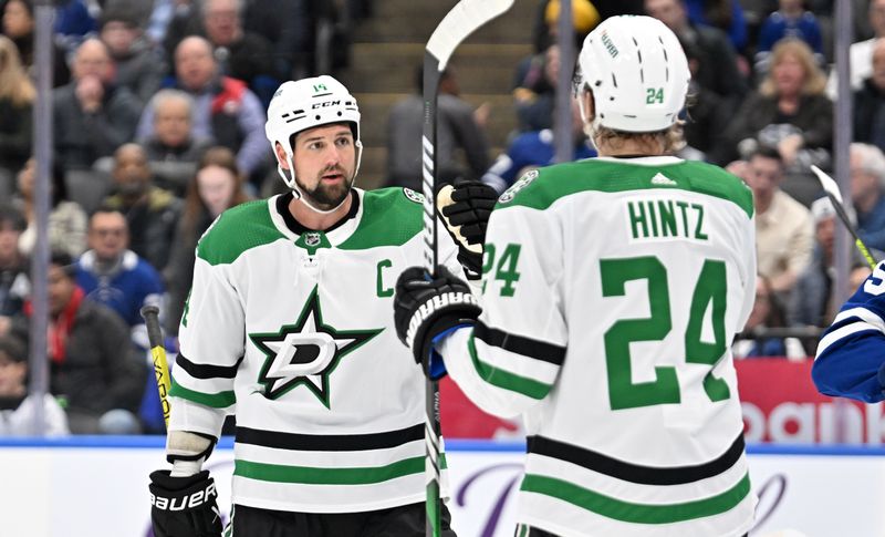 Feb 7, 2024; Toronto, Ontario, CAN; Dallas Stars forward Jamie Benn (14) celebrates with forward Roope Hintz (24) after scoring against the Toronto Maple Leafs in the first period at Scotiabank Arena. Mandatory Credit: Dan Hamilton-USA TODAY Sports