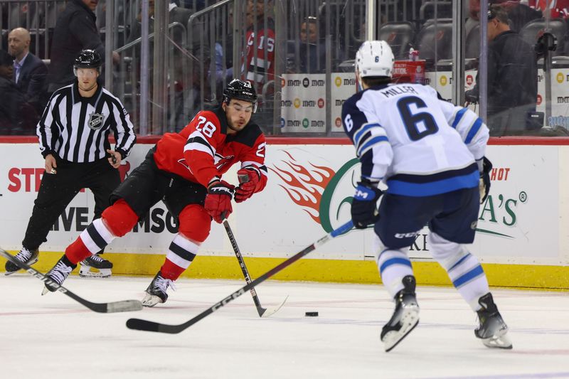 Mar 21, 2024; Newark, New Jersey, USA; New Jersey Devils right wing Timo Meier (28) plays the puck against the Winnipeg Jets during the second period at Prudential Center. Mandatory Credit: Ed Mulholland-USA TODAY Sports